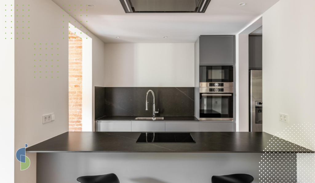 Cocina minimalista con ángulos rectos en gris oscuro y mesón en piedra sinterizada negra