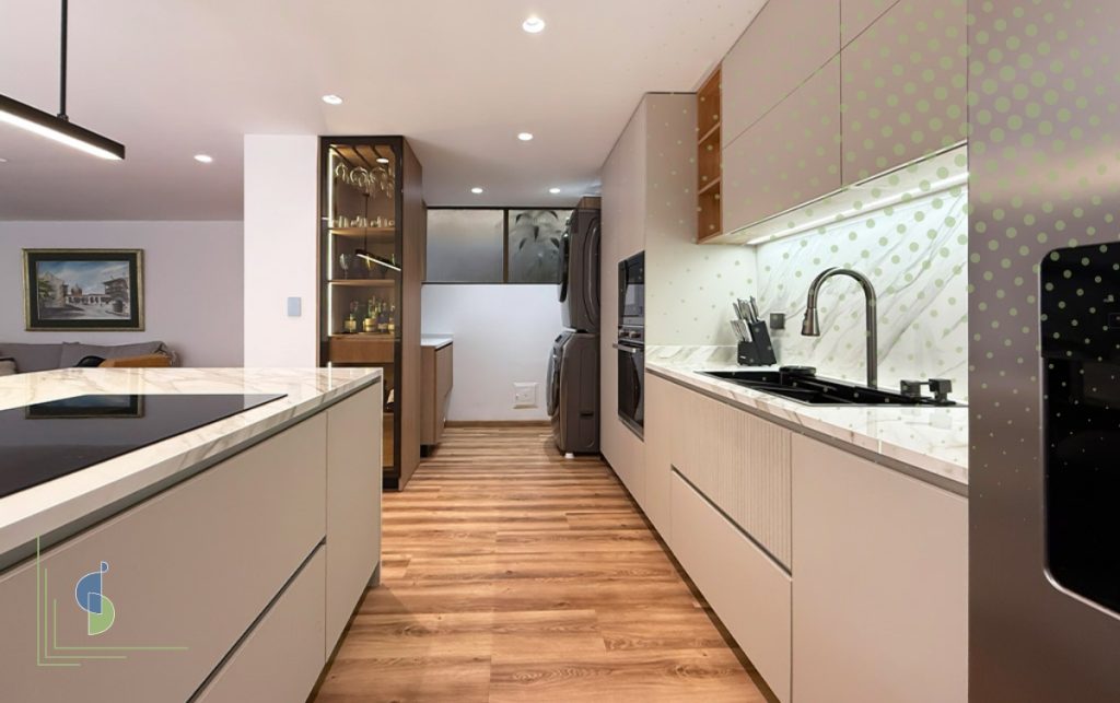 Cocina lineal en tonos greige con enchapes en madera y mesón en piedra sinterizada veteada
