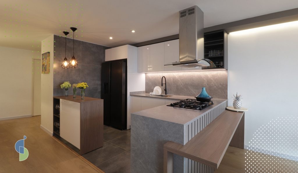 Cocina abierta con piso de porcelanato y salpicadero de piedra, superficies que reflejan el sonido hacia la sala