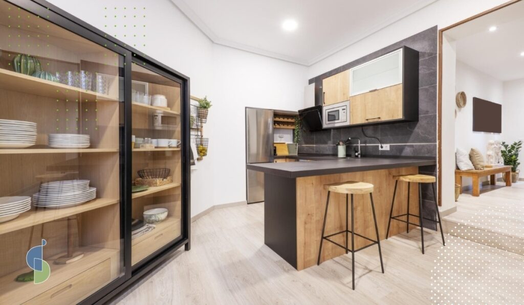 apartamento con vitrina de puerta corredera en perfil negro y madera junto a cocina de muebles cerrados